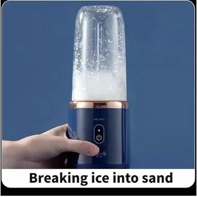 Handheld blender with ice in a clear container against a blue background kitchen