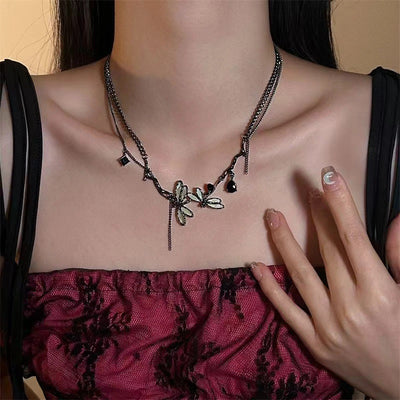 Necklace with floral design worn by a person, focusing on the jewelry.