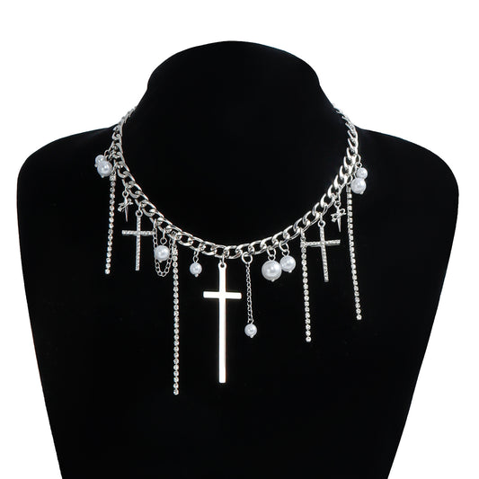 Necklace with cross and pearl pendants on a black mannequin bust.